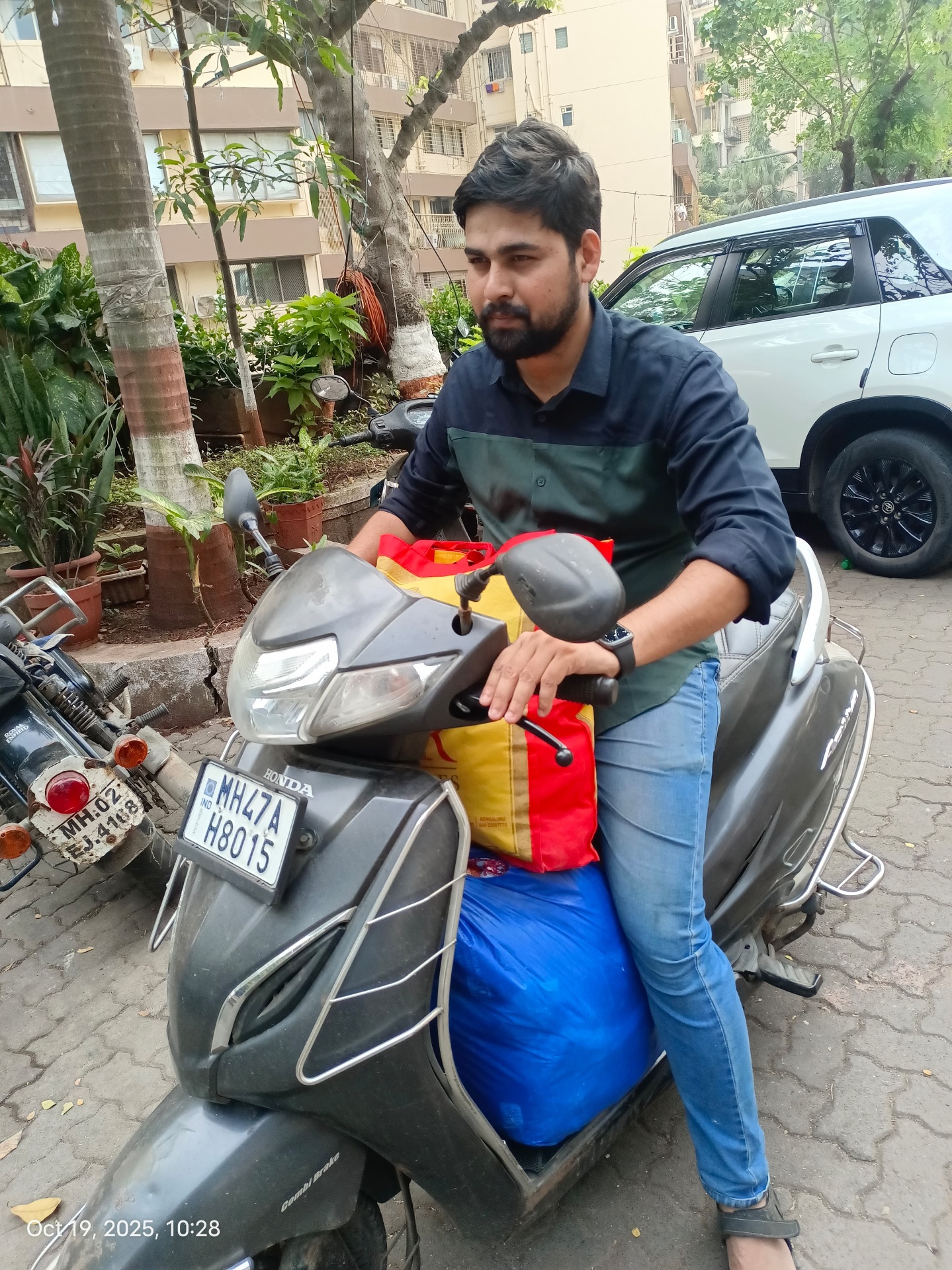TWIN team member picking up a textile donation on a scooter in Mumbai